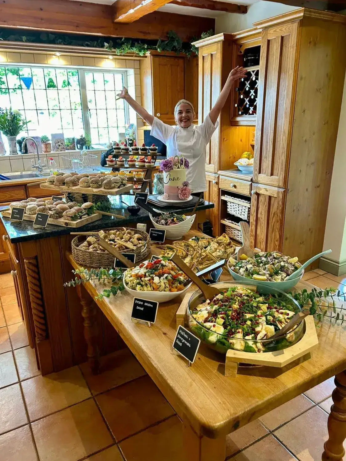Rustic wooden board loaded with savory grazing items, cheeses, and crackers
