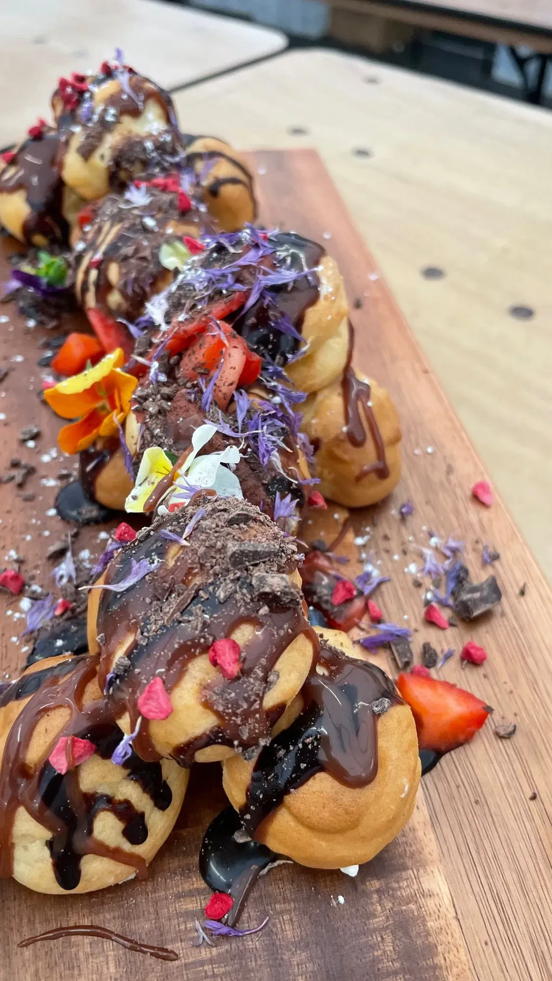 Large dessert platter with a variety of cakes, fruit, and chocolates